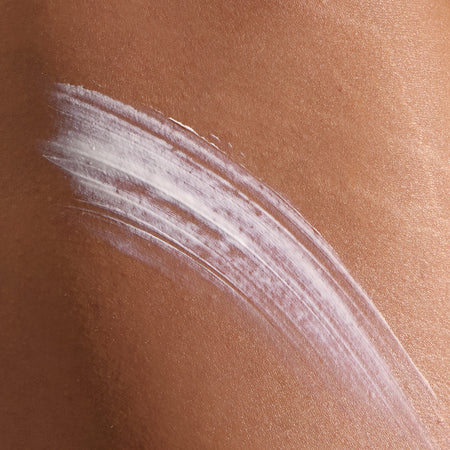 Model has applied Super Smooth onto their skin. Swiping it across.